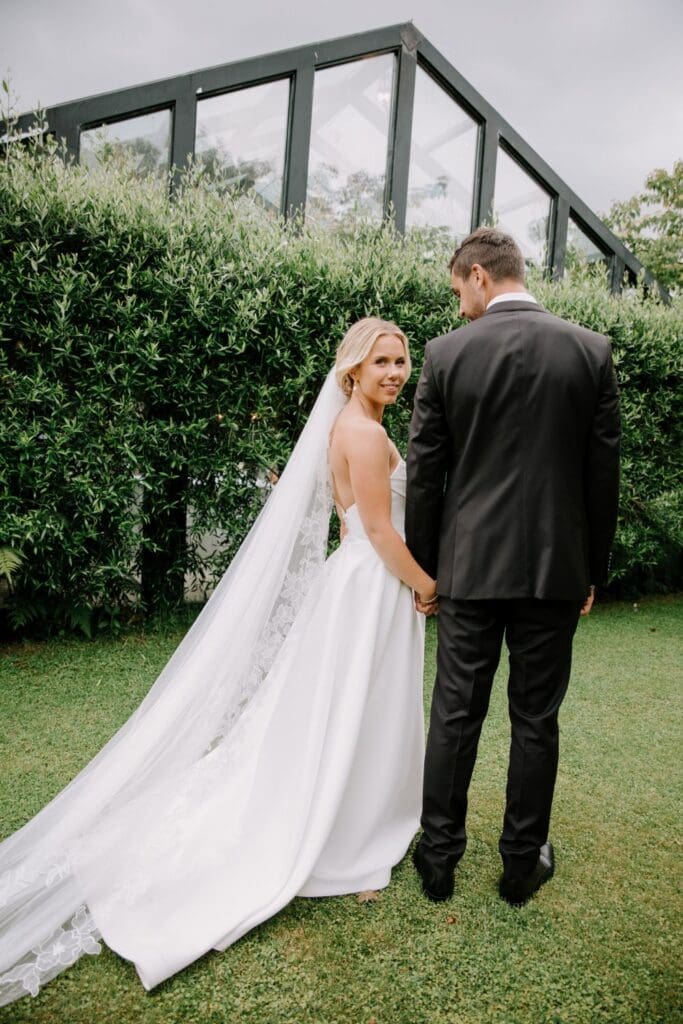 Real bride wearing the Prim Lace Edge Veil with the Windsor Gown