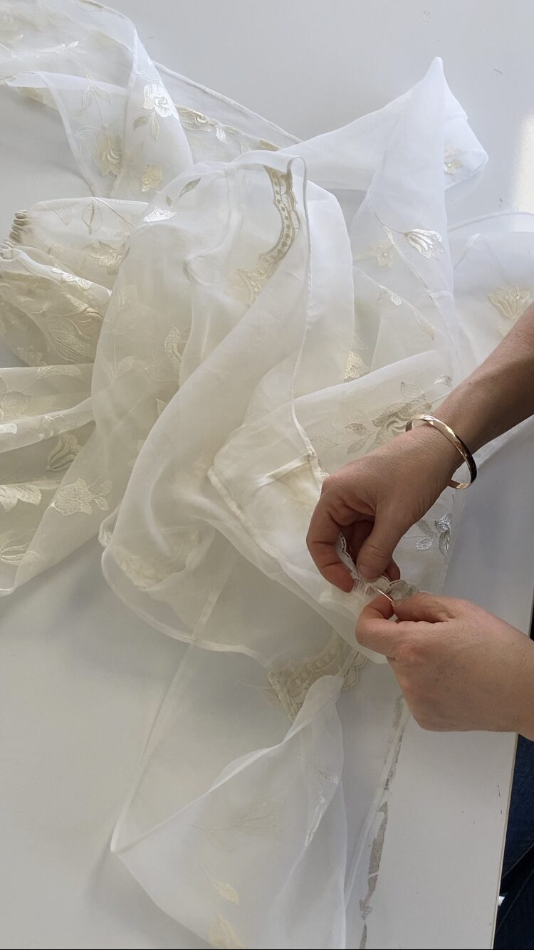 Hand stitching the scalloped lace edging