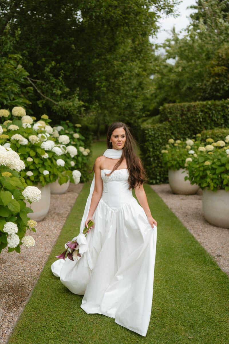 Silk basque waist wedding dress in garden setting