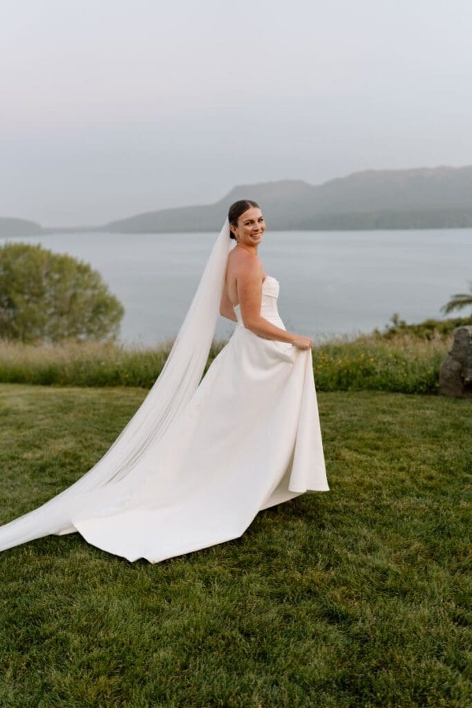 Bride wearing ivory strapless wedding dress with neck drape
