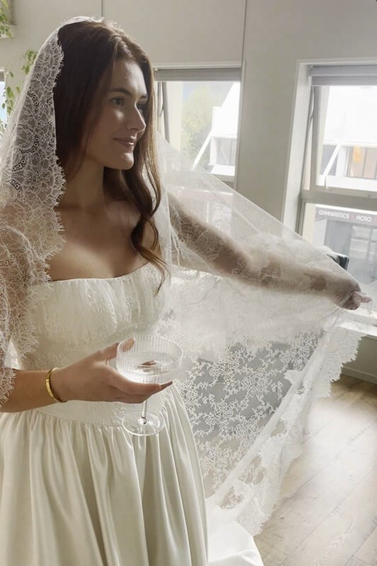 Bride-to-be trying the Chantilly Lace Veil with the Vivian lace wedding dress