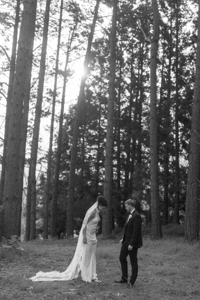 Bride wearing high neck wedding dress with lace veil