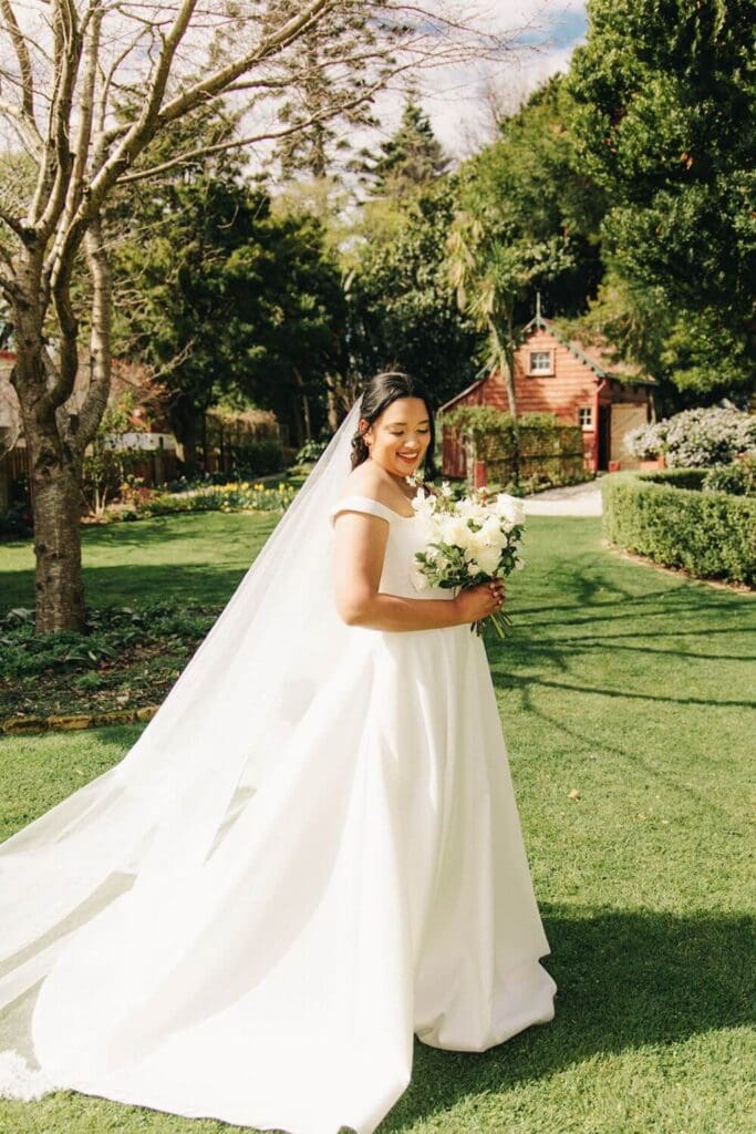 Bride wearing the Claudette Gown with the Eillish lace edge wedding veil